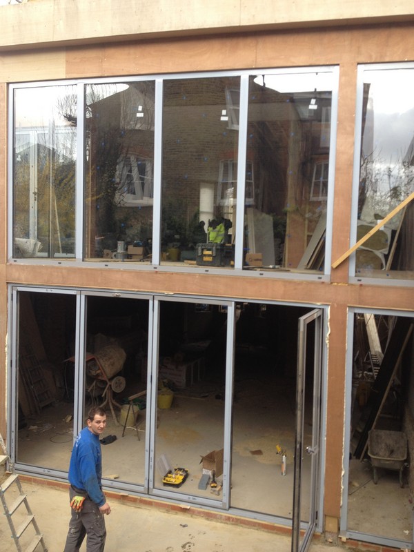 Aluminium bi-fold doors with two-storey glazing in Holland Park