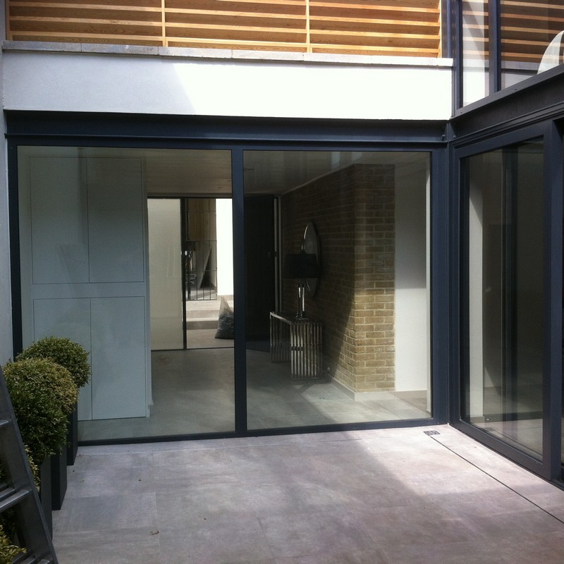 Floor-to-ceiling sliding doors opening to courtyard in Holland Park