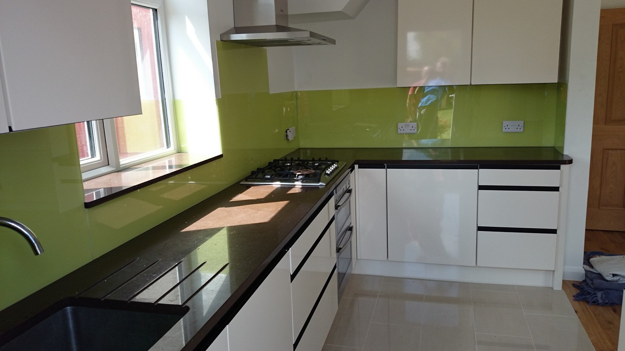 Lime green glass kitchen splashback installed by Holland Park glaziers