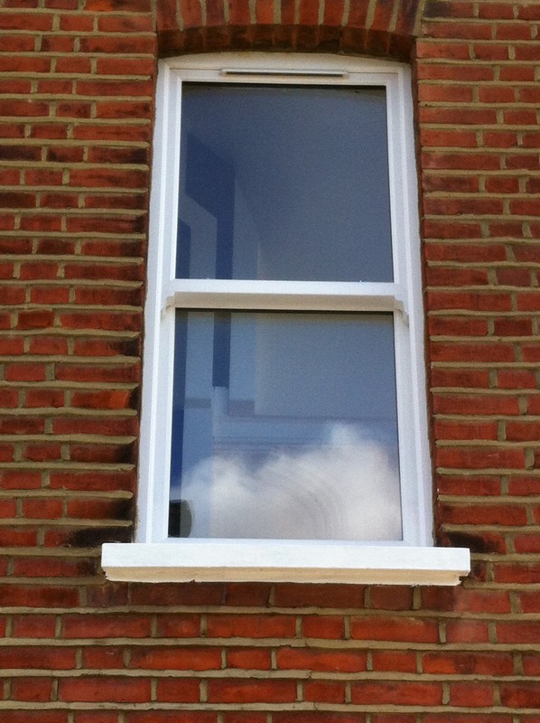 uPVC sash window on Victorian red brick house in Holland Park